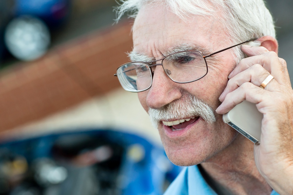 Elder man talking on his mobile phone