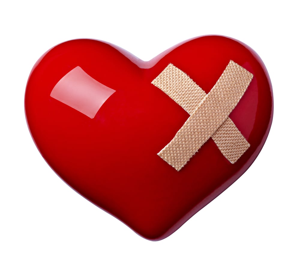 close up of a heart shape with bandage on white background